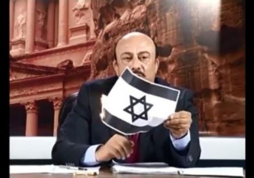 بالفيديو الإعلامي الأردني زهير العزة يحرق العلم الاسرائيلي على الهواء مباشرة