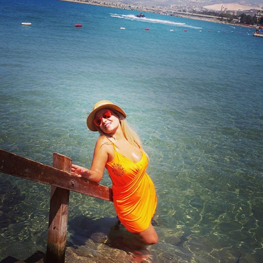 صور مادلين مطر بفستان برتقالي قصير على شواطئ لبنان 2014